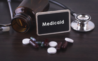 Medicaid sign with pills an stethoscope