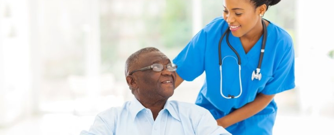 beautiful african nurse taking care of senior patient in wheelchair