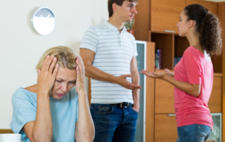 husband and wife quarrelling indoors, senior mother taking it hard