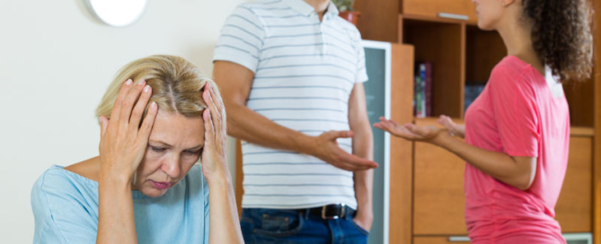 husband and wife quarrelling indoors, senior mother taking it hard