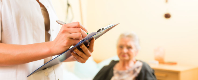 young nurse and female senior in nursing home, measurements are taken or administrative duties taken care of