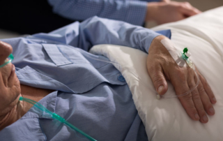close-up of terminally ill man's hand with drip