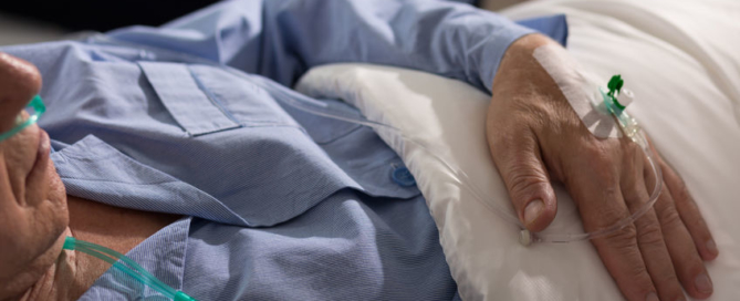 close-up of terminally ill man's hand with drip