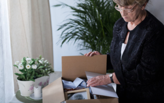 widow is closing box with things of her husband