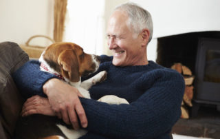 senior man relaxing at home with pet dog