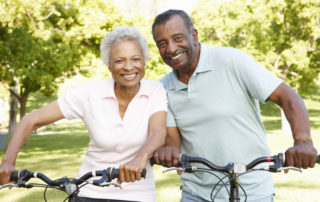 senior african american couple cycling in park