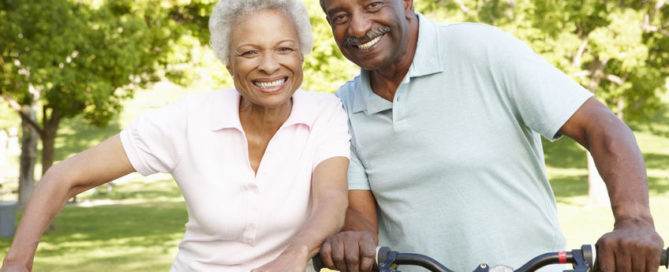 senior african american couple cycling in park